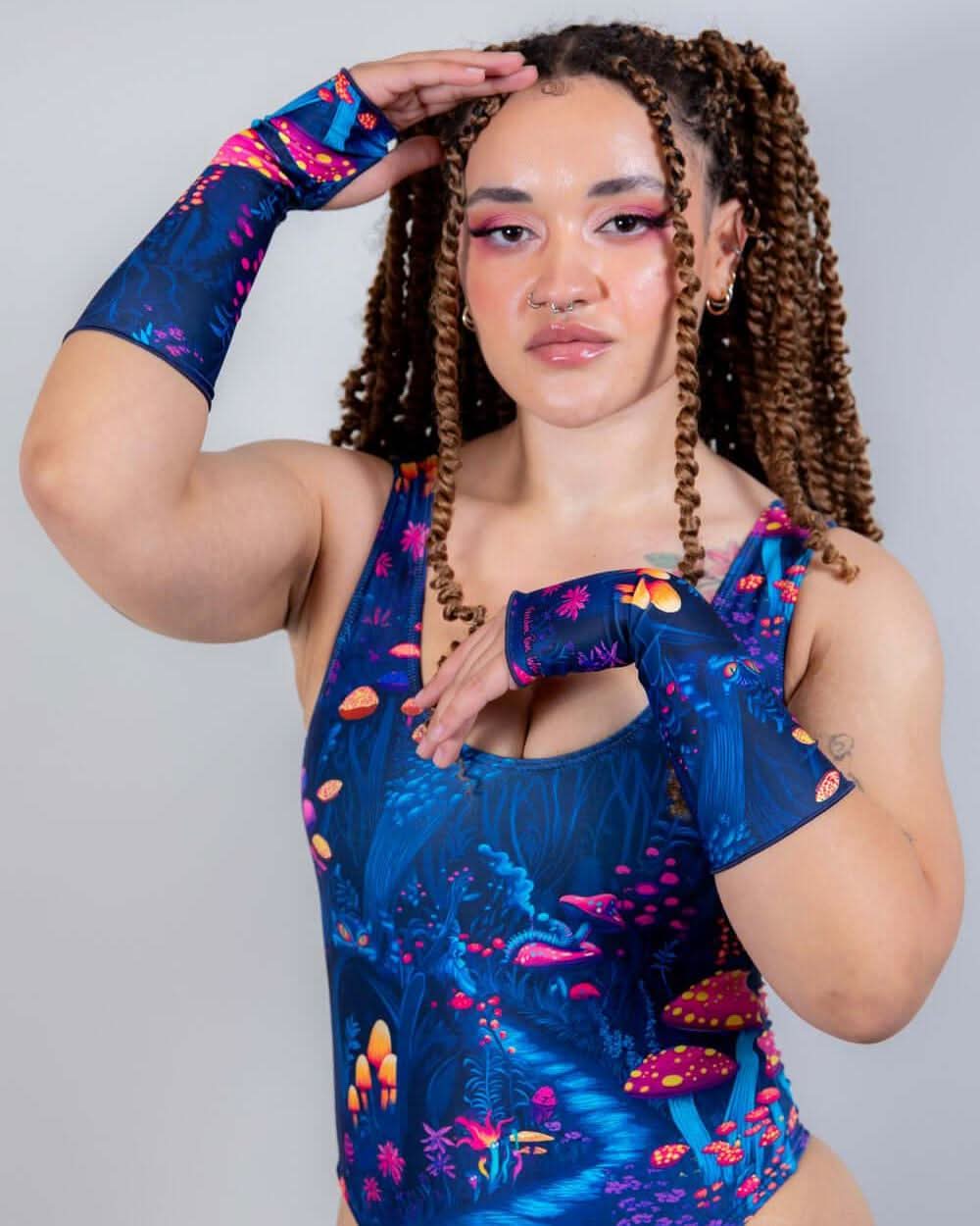 Model wearing Wildwood Gloves with a matching bodysuit, showcasing the Alice in Wonderland-inspired print.