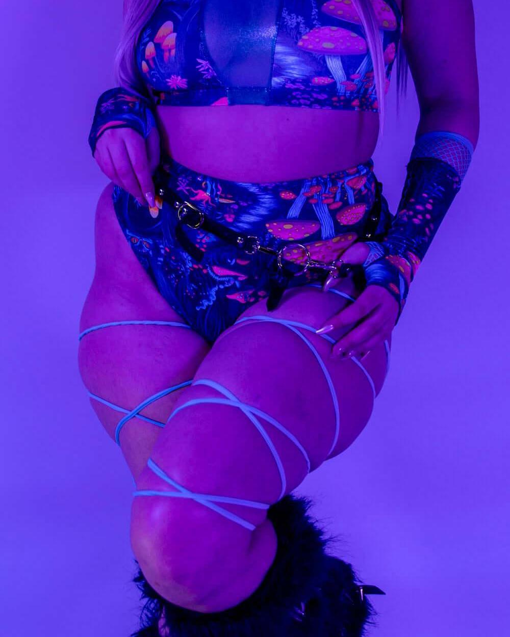 Front view of Wildwood High Waisted Bikini Bottoms under blacklight, showing UV-reactive design.