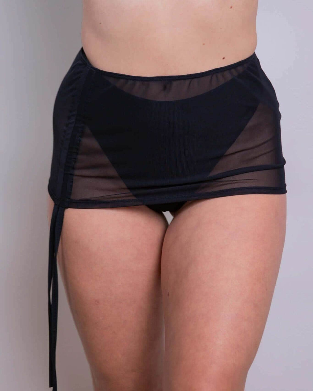 Black mesh cinch skirt with adjustable tie drawcord, perfect for rave outfits and versatile styling options.
