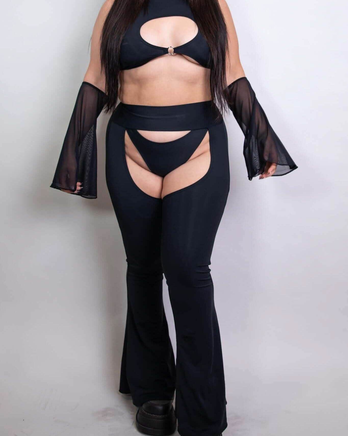 Model wearing black mesh flare sleeves with a matching crop top and cut-out pants, ideal for rave outfits and statement looks.