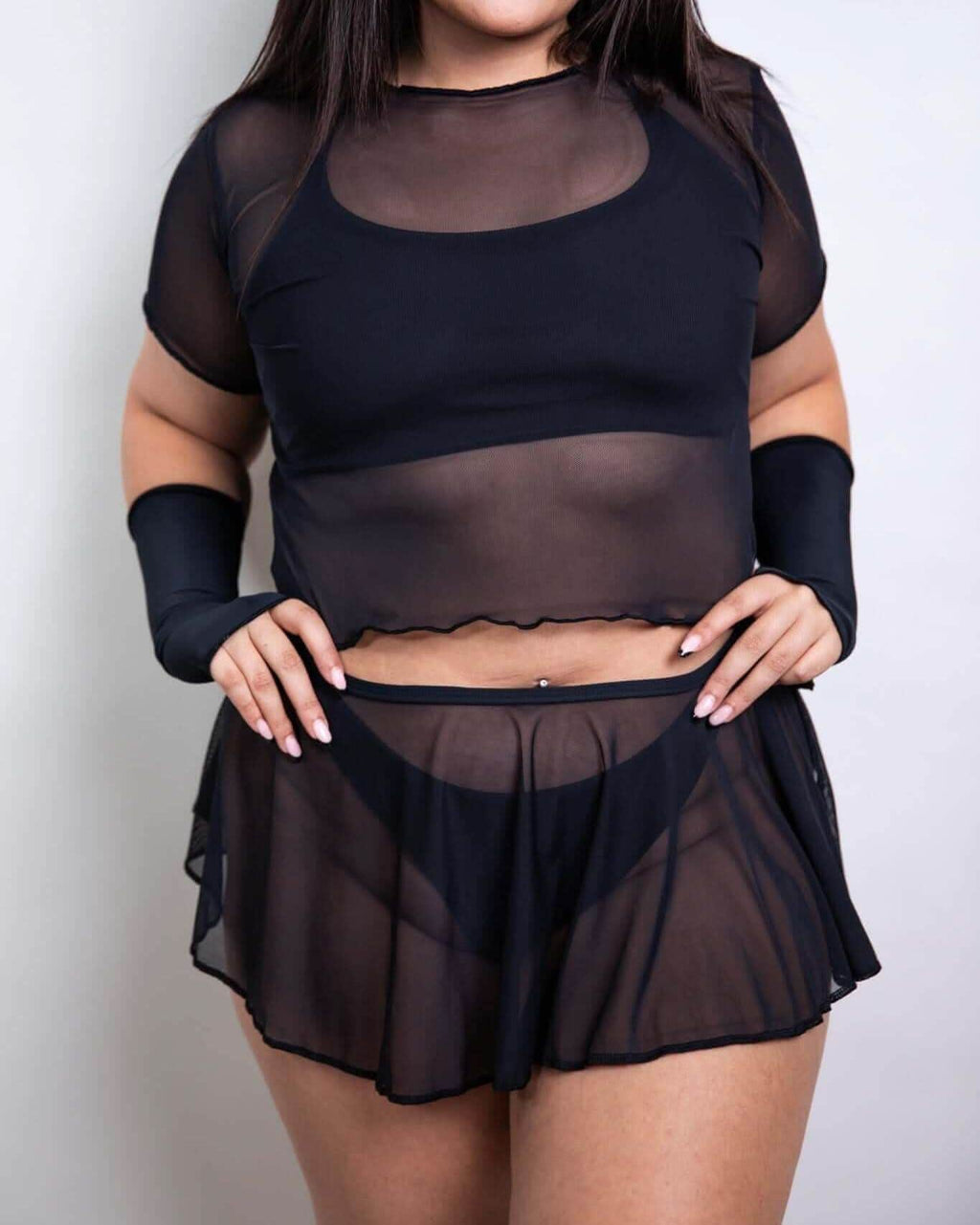 Black sheer mesh outfit featuring a cropped top and matching skirt, ideal for rave outfits and layering styles.