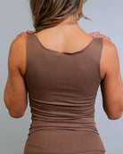 Back view of a woman wearing the Brown Coco Ribbed Lounge Tank in soft brown, ideal for cozy and stylish relaxation.