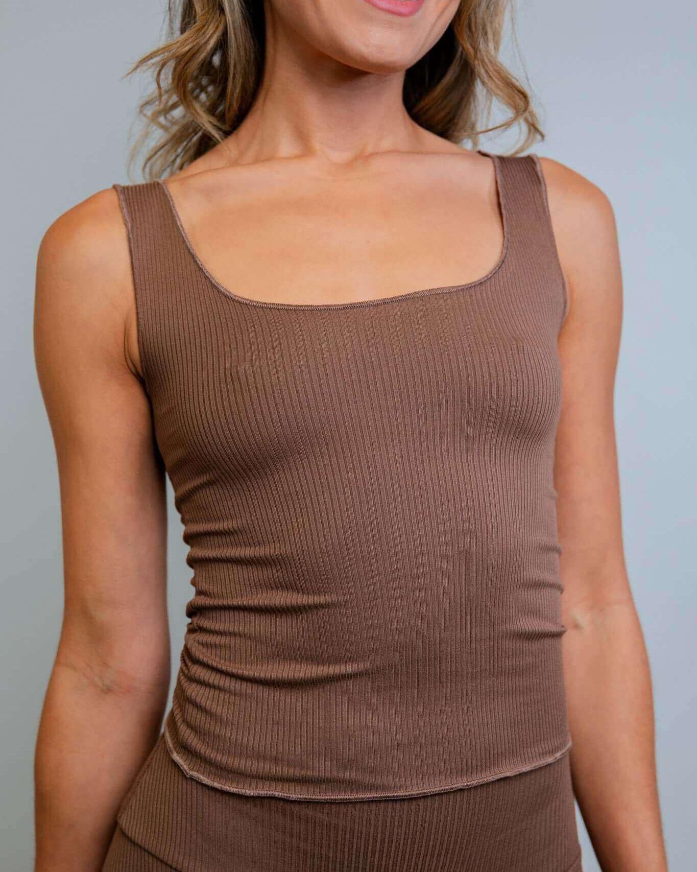 Model wearing a brown ribbed lounge tank top, showcasing its soft fabric and cozy style perfect for casual or rave outfits.