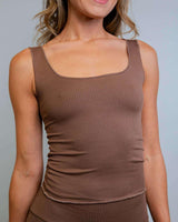 Model wearing a brown ribbed lounge tank top, showcasing its soft fabric and cozy style perfect for casual or rave outfits.
