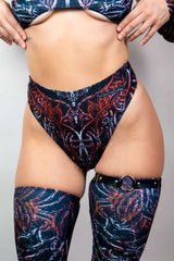 High-waisted thong in dark abstract print, paired with matching thigh-high stockings, perfect for rave outfits.