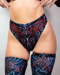 High-waisted thong in dark abstract print, paired with matching thigh-high stockings, perfect for rave outfits.