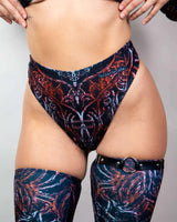 High-waisted thong in dark abstract print, paired with matching thigh-high stockings, perfect for rave outfits.