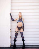 Raver wearing FRW Darkness leg sleeves and matching outfit, showcasing a bold dance-ready style against a clean backdrop.