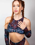 Model showcasing the Darkness Teaser Top, a fierce festival top with high neck and racerback design, perfect for rave outfits.