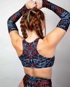 Model showcasing the Darkness Teaser Top with unique patterns, featuring high neck and racerback design, perfect for rave outfits.