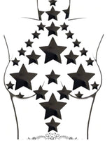 Black star-shaped nipple stickers on a torso for trendy rave outfits and bold fashion statements.