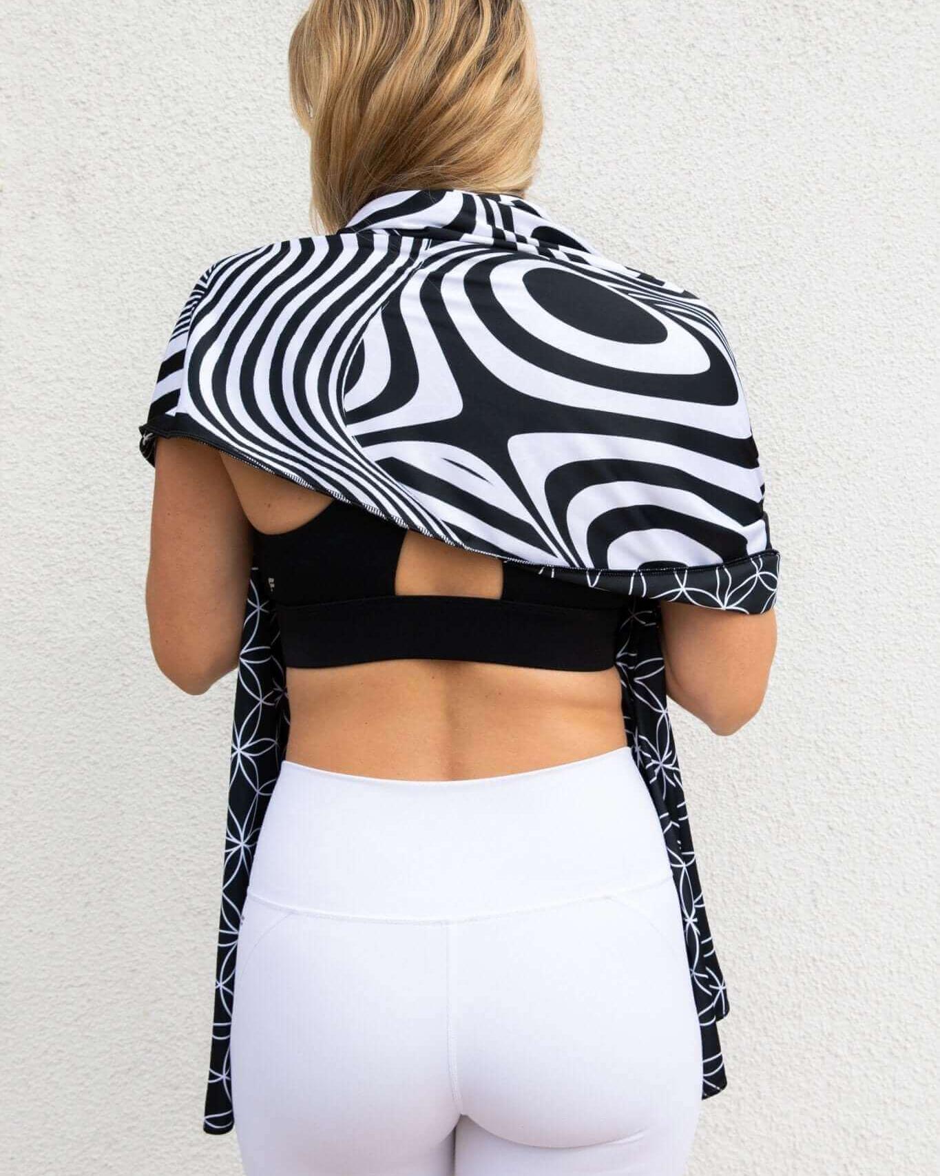 Model showcasing the Duality Festival Scarf with a bold optical illusion pattern, perfect for rave outfits.