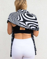 Model showcasing the Duality Festival Scarf with a bold optical illusion pattern, perfect for rave outfits.
