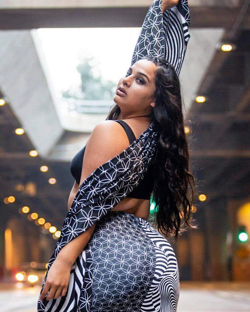 Model showcases Duality Festival Scarf with Flower of Life pattern, styled for rave outfits in an urban setting.