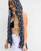Woman wearing Duality Festival Scarf with Flower of Life pattern, styled with rave outfit for a vibrant look.