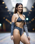 Model wearing Duality High Waisted Brazilian Bottoms and matching top in a trippy black and white pattern for rave outfits.