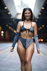 Model wears FRW Duality Wrap Bikini Top in black & white, showcasing chic graphic design for stylish beach rave outfits.