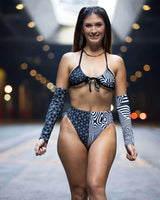 Model wears FRW Duality Wrap Bikini Top in black & white, showcasing chic graphic design for stylish beach rave outfits.