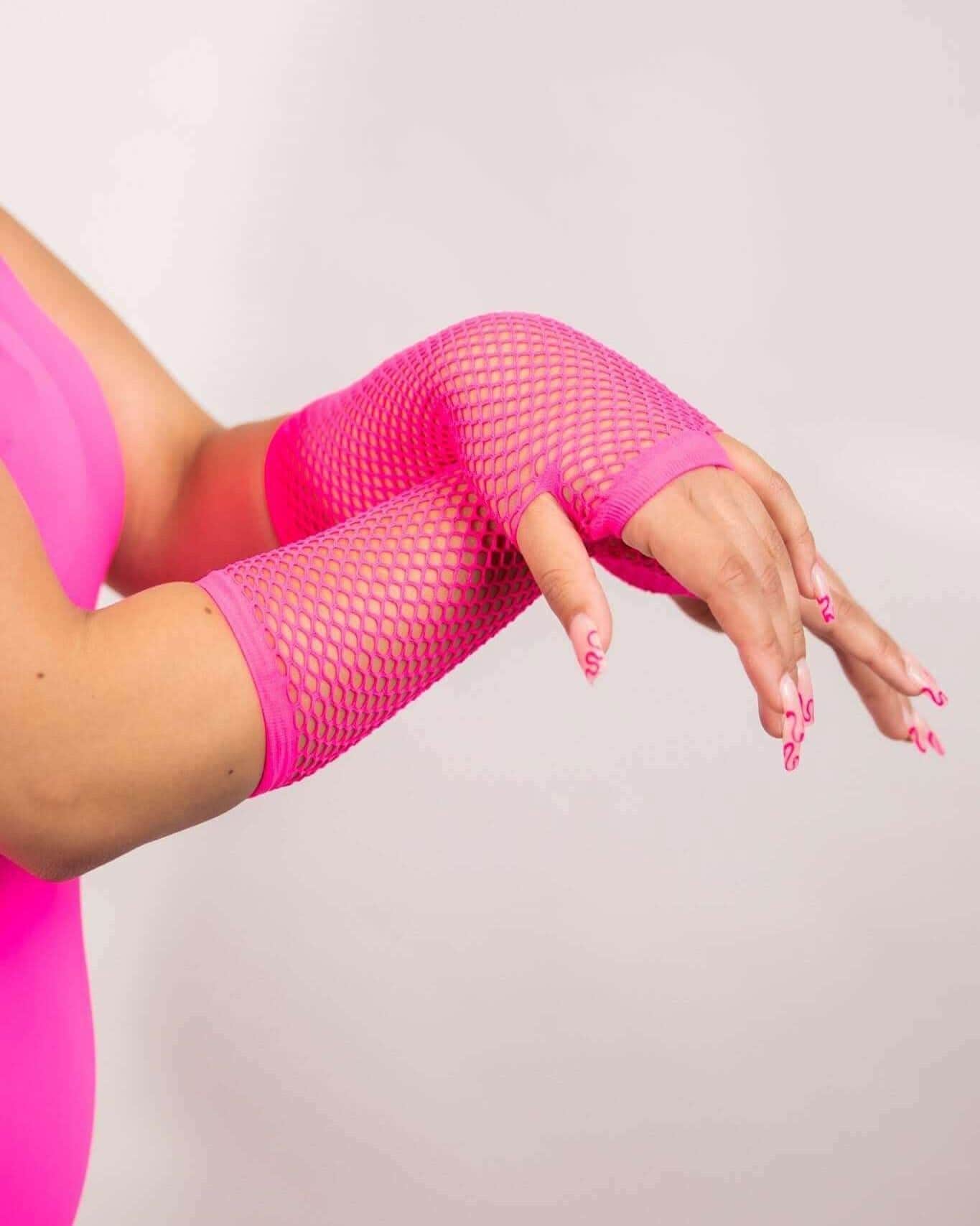 Neon pink fishnet arm sleeves model wearing, perfect accessory for rave outfits and festival looks. Soft and stretchy design.