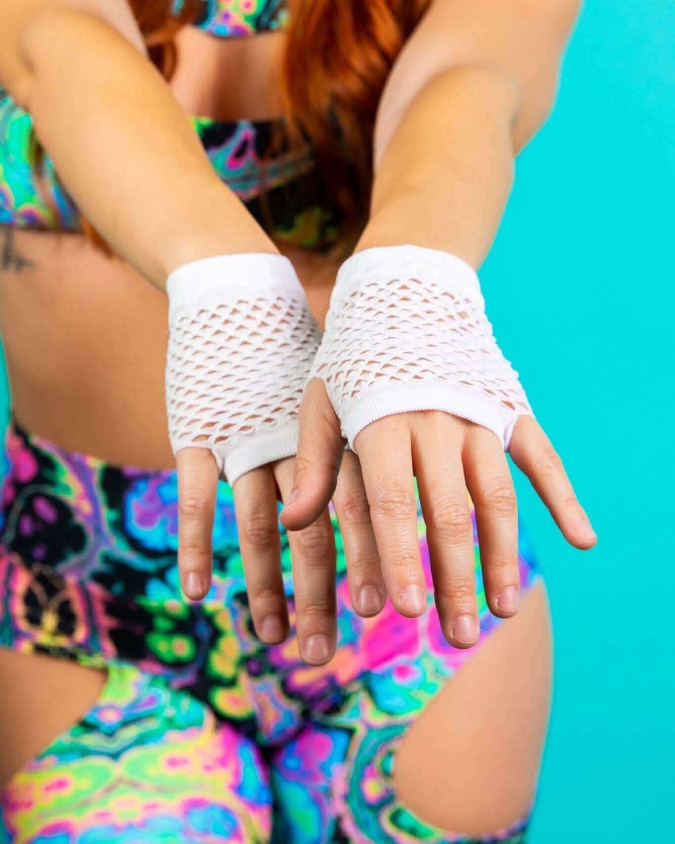 White fishnet gloves showcased on hands, perfect accessory for rave outfits and festival style. Soft and stretchy material.