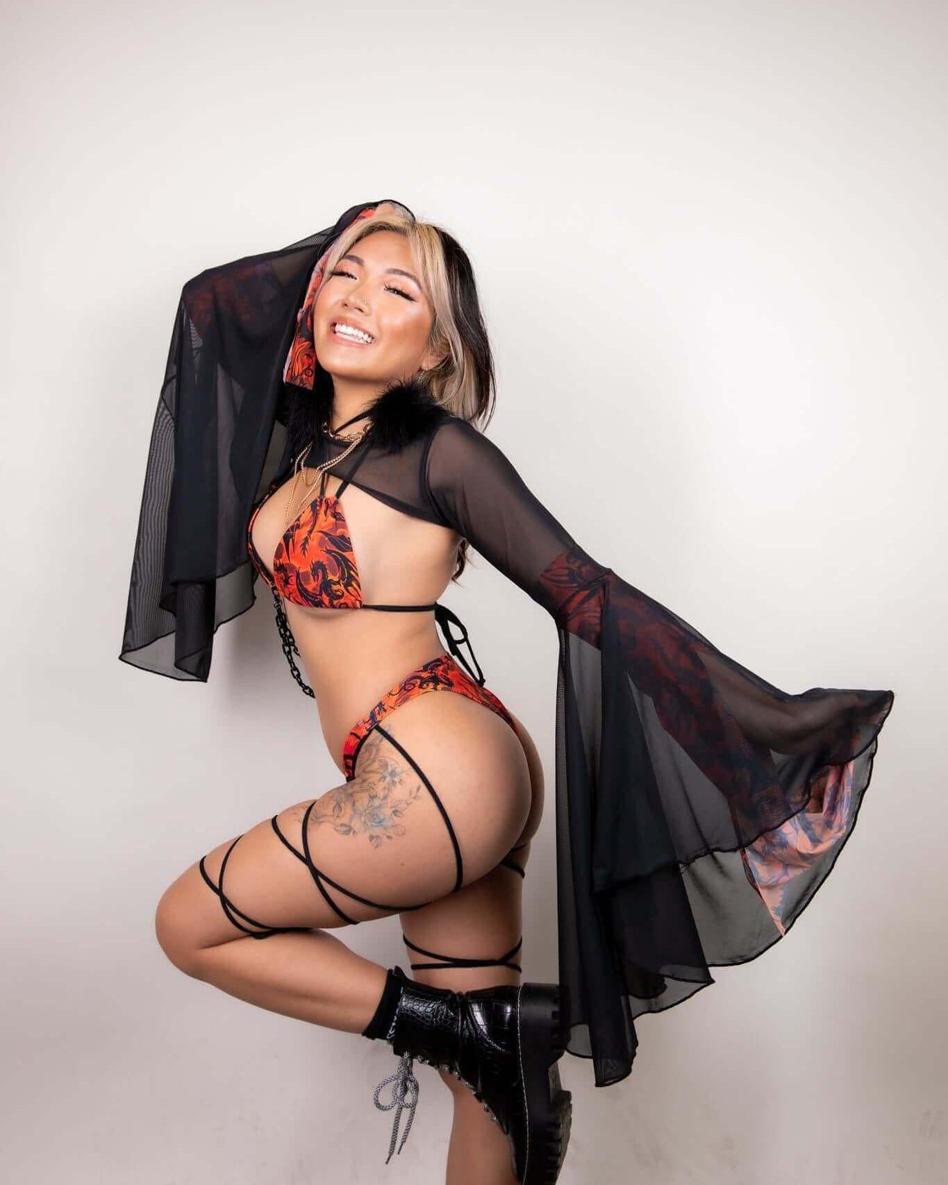 Model showcasing the Forbidden Strappy Bikini Top with flowing sleeves, perfect for rave outfits and festival looks.