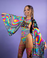 Model showcasing vibrant HAPPIER Festival Scarf and colorful rave outfit against a purple backdrop.