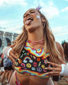 Woman in rainbow underboob top showcasing vibrant design at a festival, perfect for rave outfits and standout style.
