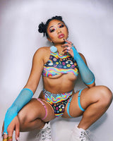 Rave outfit featuring a vibrant rainbow teaser top and colorful accessories, perfect for EDM lovers and festival vibes.