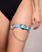 Blue Heartbreaker leg garter with heart symbol and chain detail, perfect for rave outfits and festival fashion.