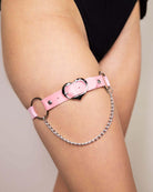 Pink Heartbreaker leg garter with lightweight chain detail, perfect for rave outfits and festival fashion.