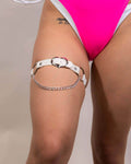 White Heartbreaker leg garter with chain detail, perfect for rave outfits and festival looks.