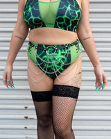 Model showcasing a green lightning print bikini set with body chain, perfect for stylish rave outfits.