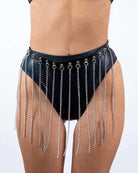 Stylish rave outfit with silver chain detailing on a high-waisted black faux leather bottom. Perfect for dance festivals.