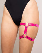 Pink leather adjustable leg garter, perfect accessory for rave outfits and edgy festival fashion.