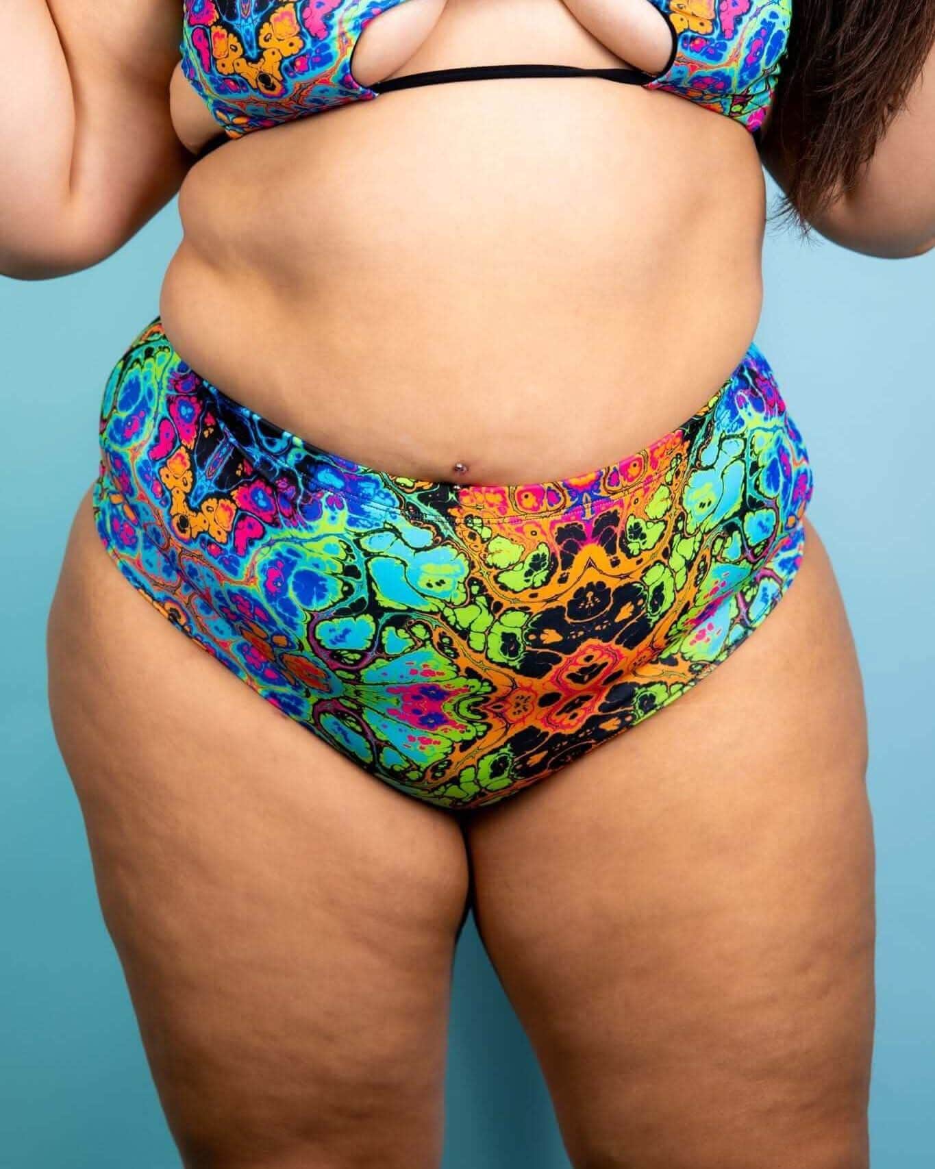 Lucidity High Waisted Brazilian Bottoms in psychedelic rainbow design, perfect for rave outfits, showcasing a cheeky back.