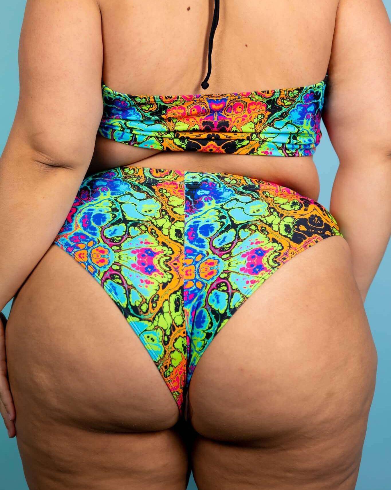 Lucidity High Waisted Thong in vibrant psychedelic rainbow design, showcasing extra cheeky cut and high-waisted style.