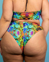 Lucidity High Waisted Thong in vibrant psychedelic rainbow design, showcasing extra cheeky cut and high-waisted style.