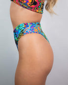 Lucidity High Waisted Thong in vibrant psychedelic rainbow design, perfect for rave outfits and showcasing curves.