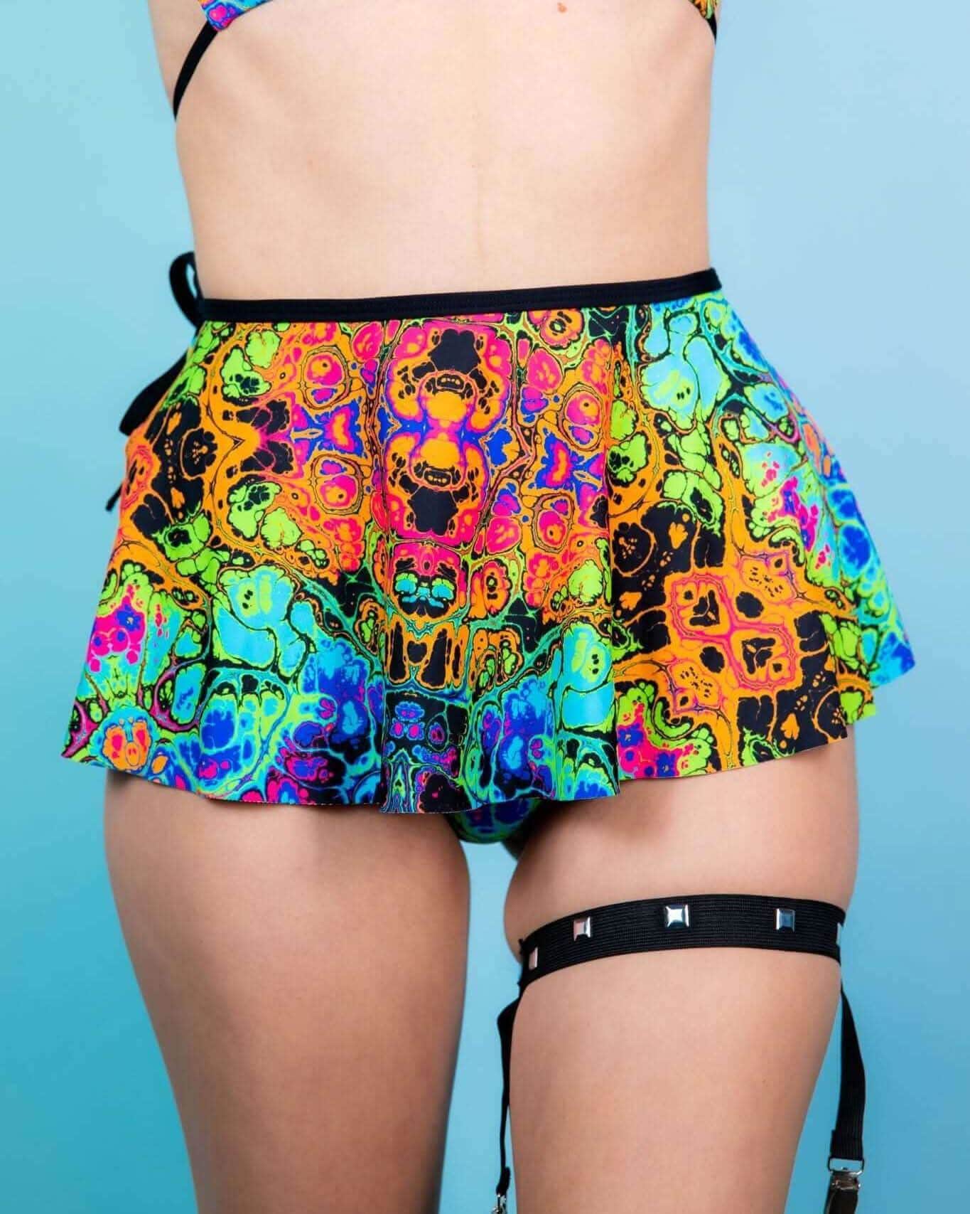 Colorful Lucidity Swirl Skirt paired with a vibrant bikini, perfect for rave outfits and festival fashion.