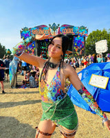 Festival-goer in rainbow rave outfit posing at Sherwood Court, showcasing vibrant festival style and energy.