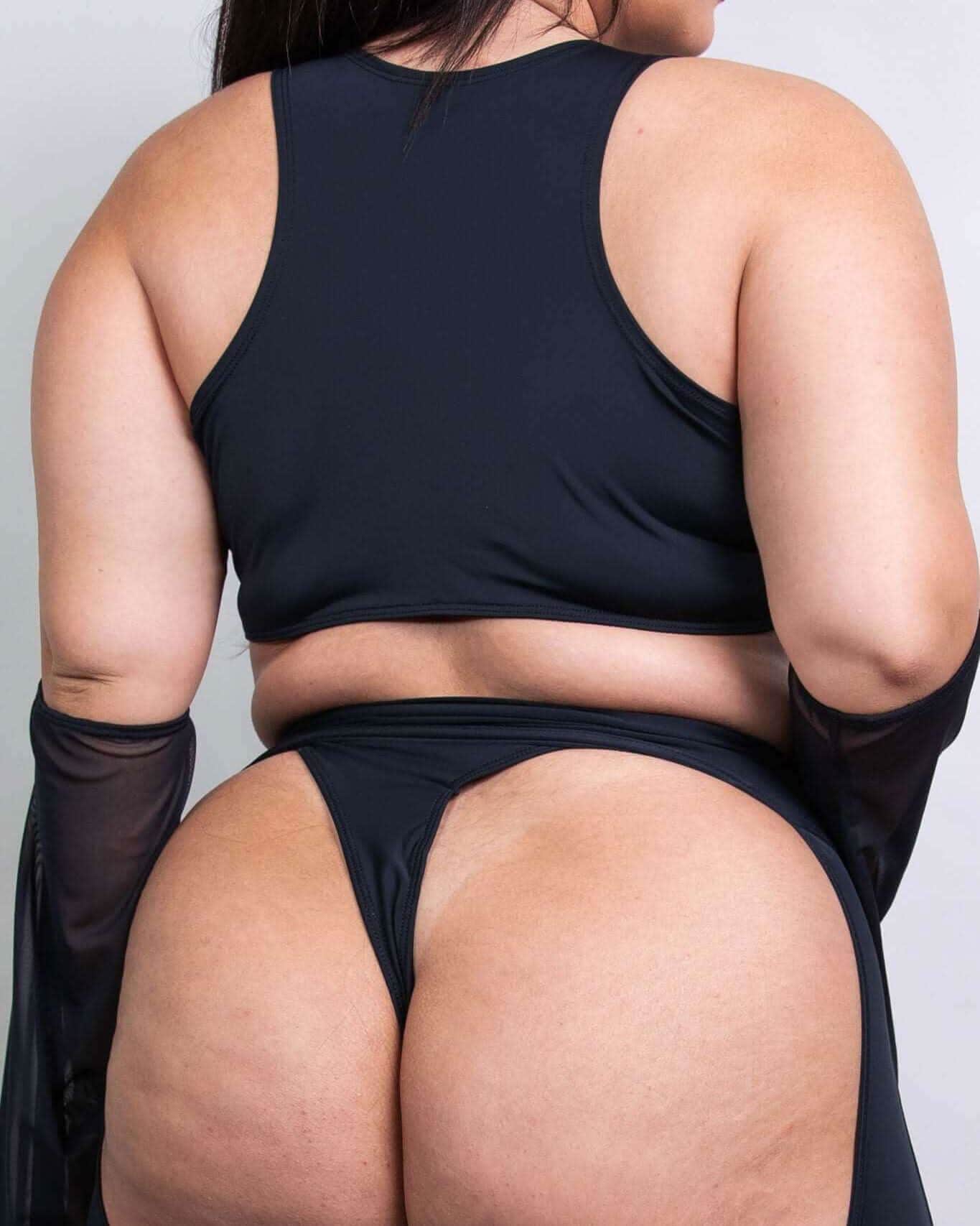 Matte black keyhole top with racer back design, showcasing stylish underboob exposure and O-ring detail, perfect for rave outfits.