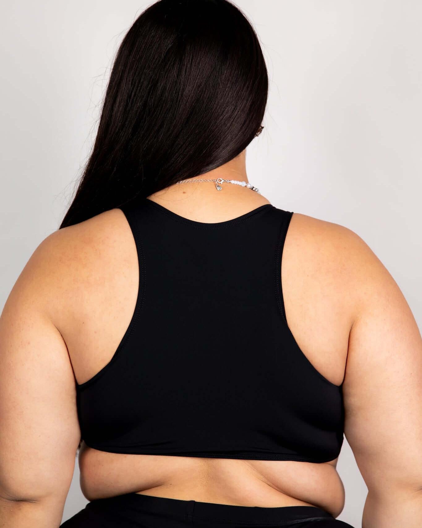 Matte black teaser top for women, showcasing racerback design and underboob cut, perfect for rave outfits.