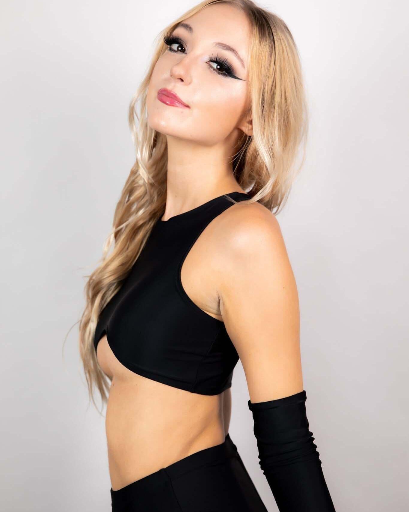 Model showcasing the Matte Black Teaser Top, a trendy underboob top perfect for rave outfits and EDM events.