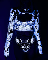 Woman wearing a neon Mechanoid rave outfit, featuring a glowing crop top and high-waisted thong, perfect for festivals.
