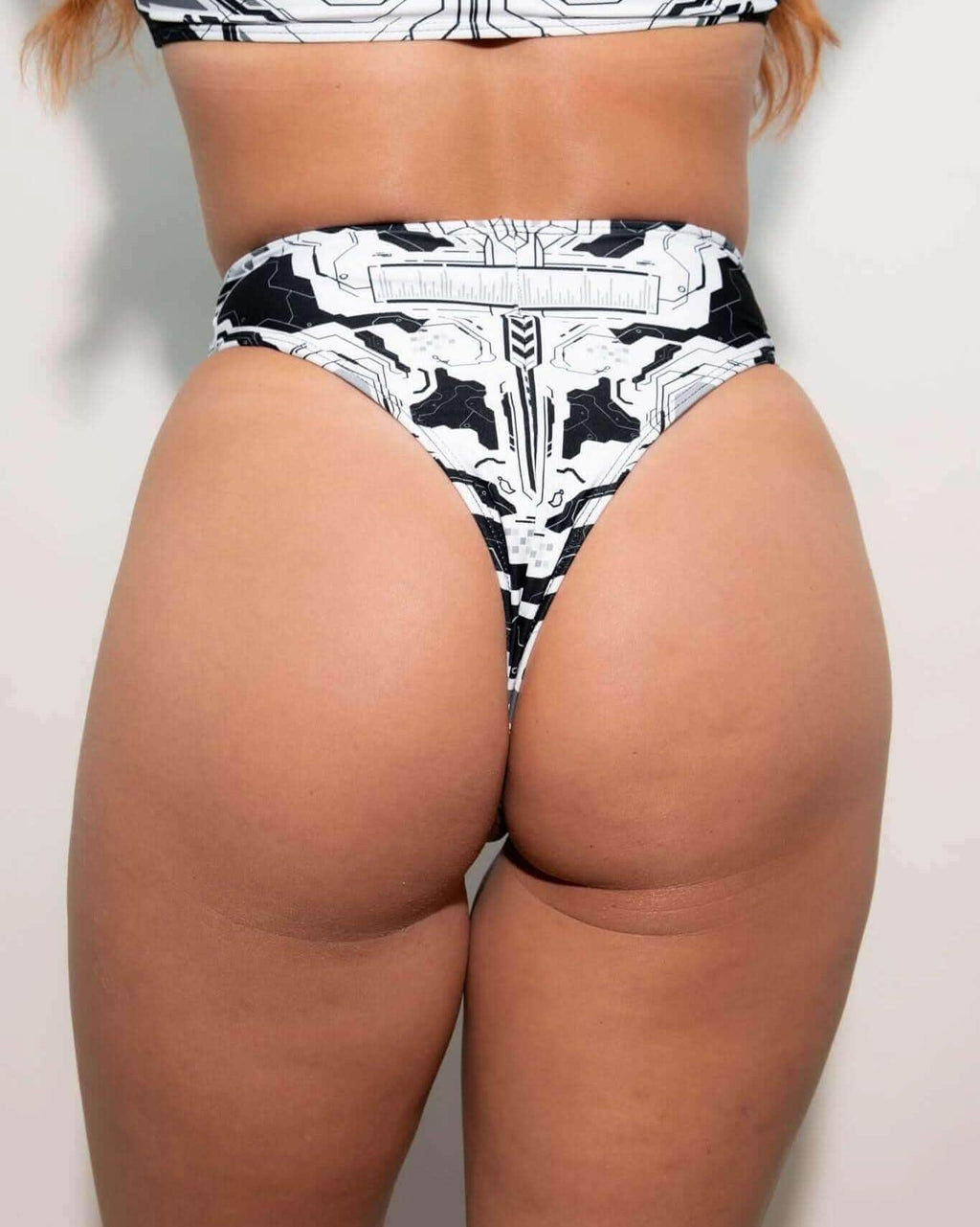Mechanoid high waisted thong in black and white, showcasing cheeky cut and rave outfit style.