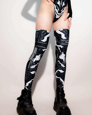 Mechanoid leg sleeves in black, perfect for rave outfits, featuring robotic designs and eco-friendly materials.