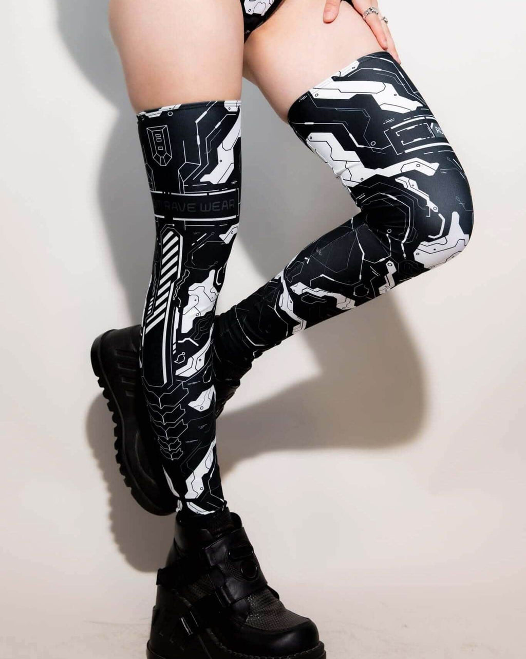 Mechanoid Leg Sleeves in black and white design, perfect for festival rave outfits, featuring eco-friendly materials.