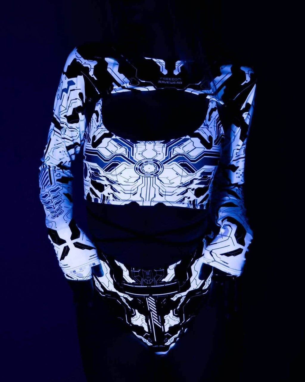Mechanoid Reversible Lush Top featuring a vibrant circuit design, perfect for rave outfits, in a stylish blacklight setting.