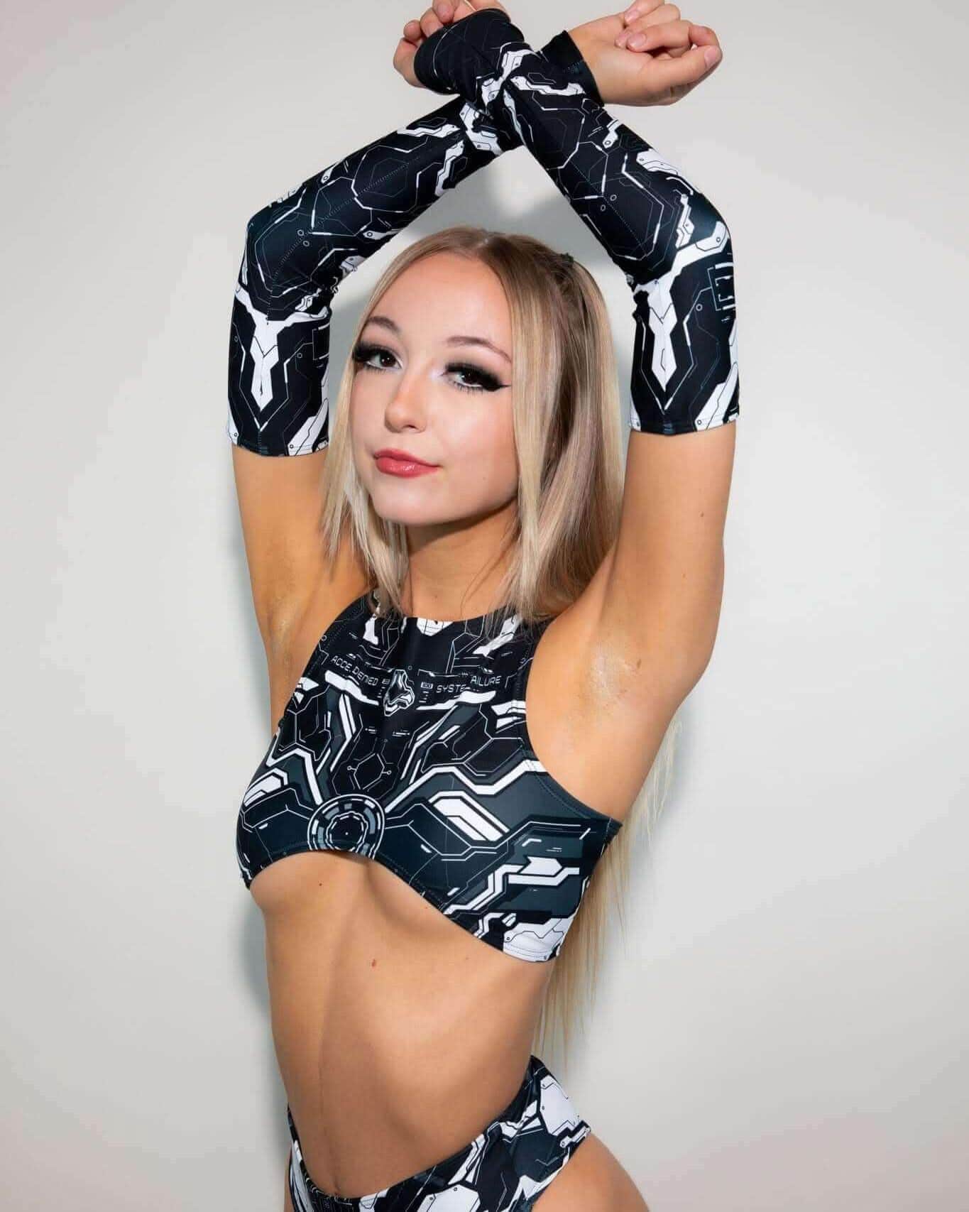 Model showcasing the Mechanoid Teaser Top in black, perfect for rave outfits with stylish underboob design.