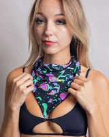 Young woman wearing a black bandana with colorful mushroom designs, perfect for rave outfits and festival looks.